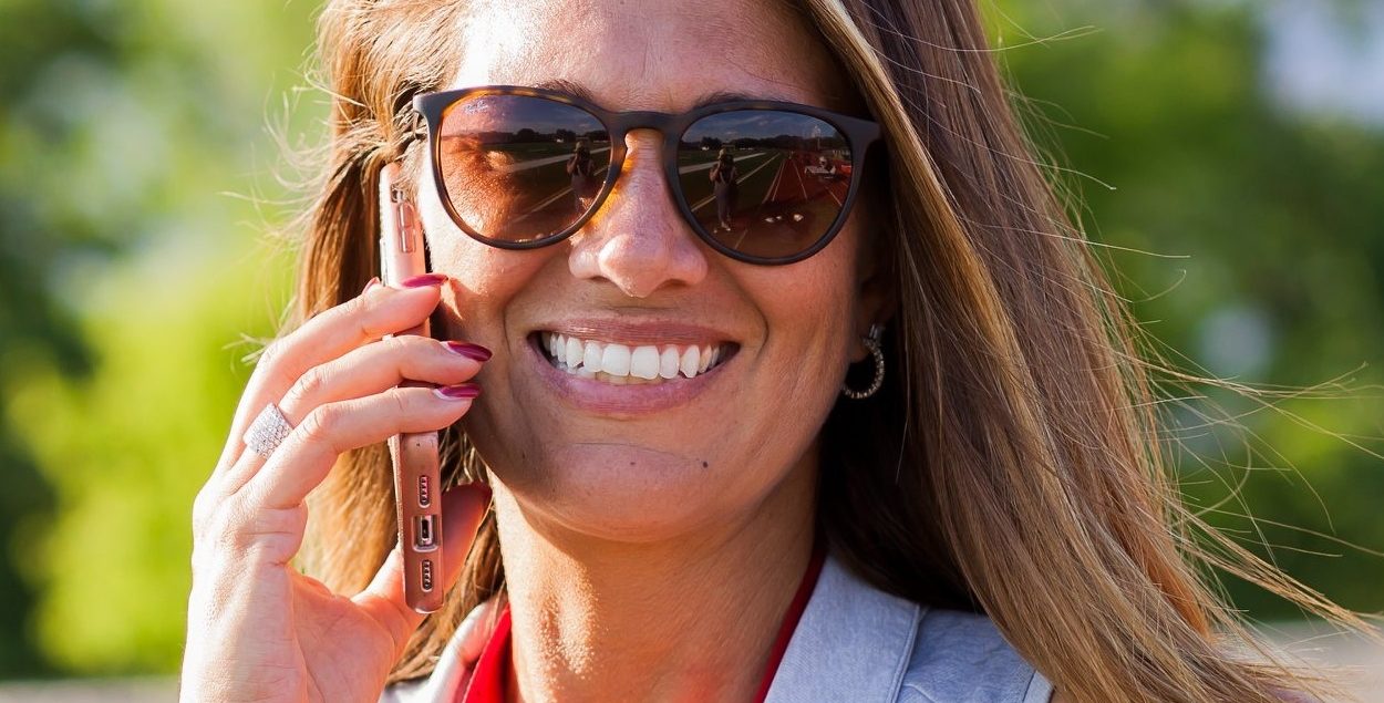 Fire and Ice SC Head Coach/Owner Lindsay Kennedy Eversmeyer smiles while talking on the phone